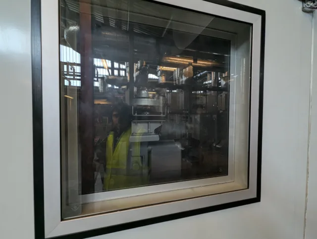 Energy consultant inspecting industrial equipment for energy reporting and carbon footprinting