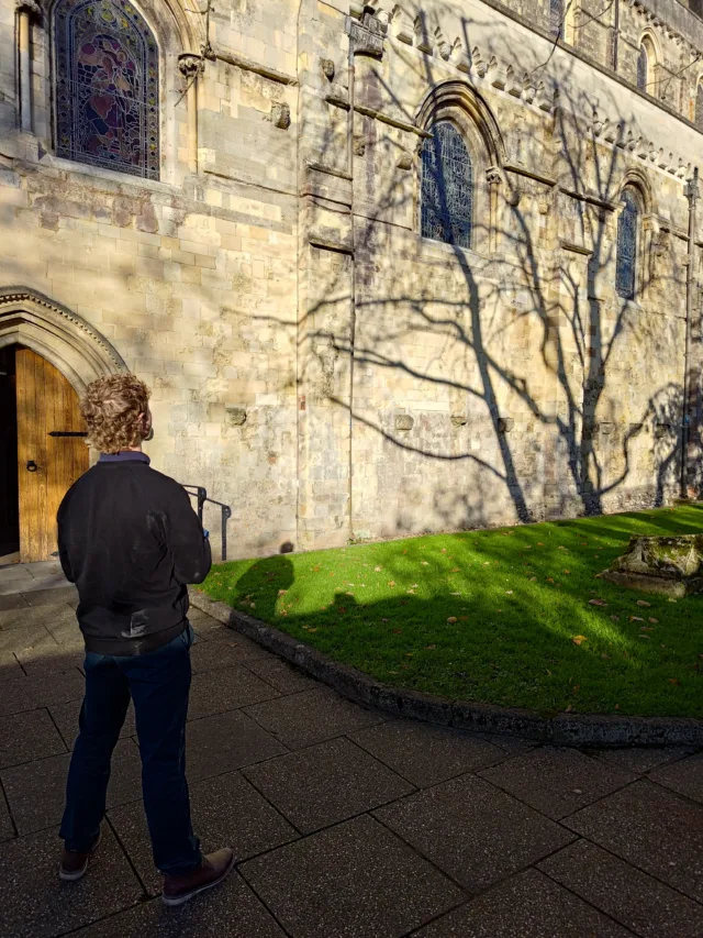 Energy assessor surveying a historic stone building for heat loss calculations