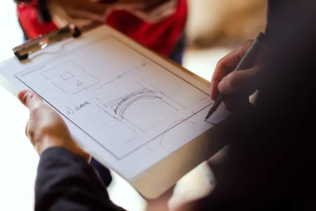 Consultant annotating a building plan during an energy and carbon assessment