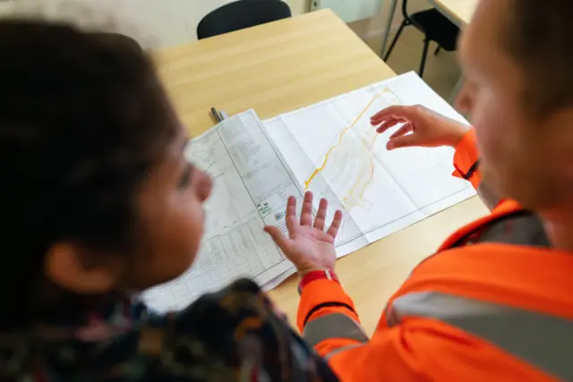 Sustainability consultants reviewing site plans during project planning